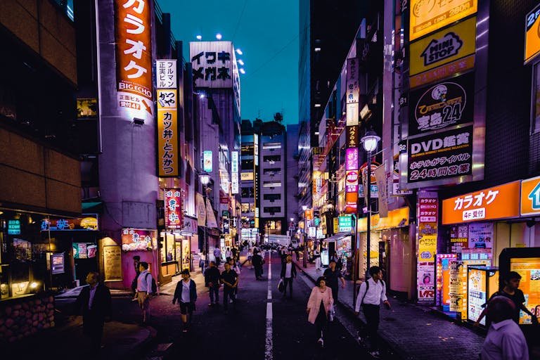 People Walking On The Streets Surrounded By Buildings